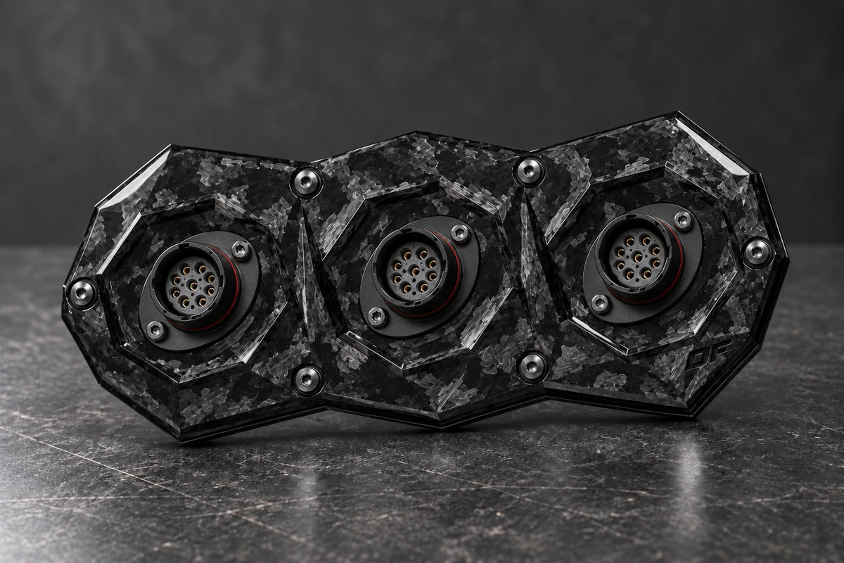 Dorifab medium triple forged carbon bulkhead connector plate, hero view. Illustrative connector installation; connectors not included.