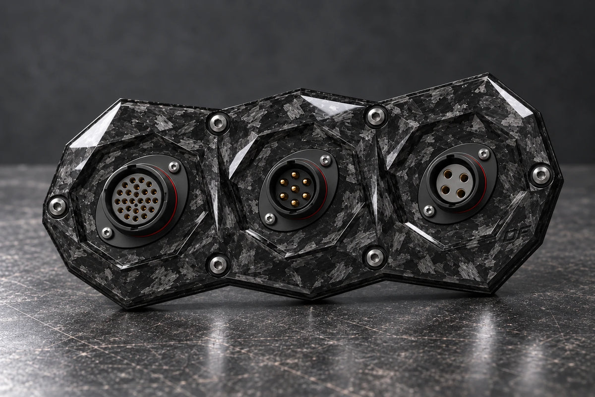 Dorifab medium triple forged carbon bulkhead connector plate, mixed shell sizes view. Illustrative connector installation; connectors not included.