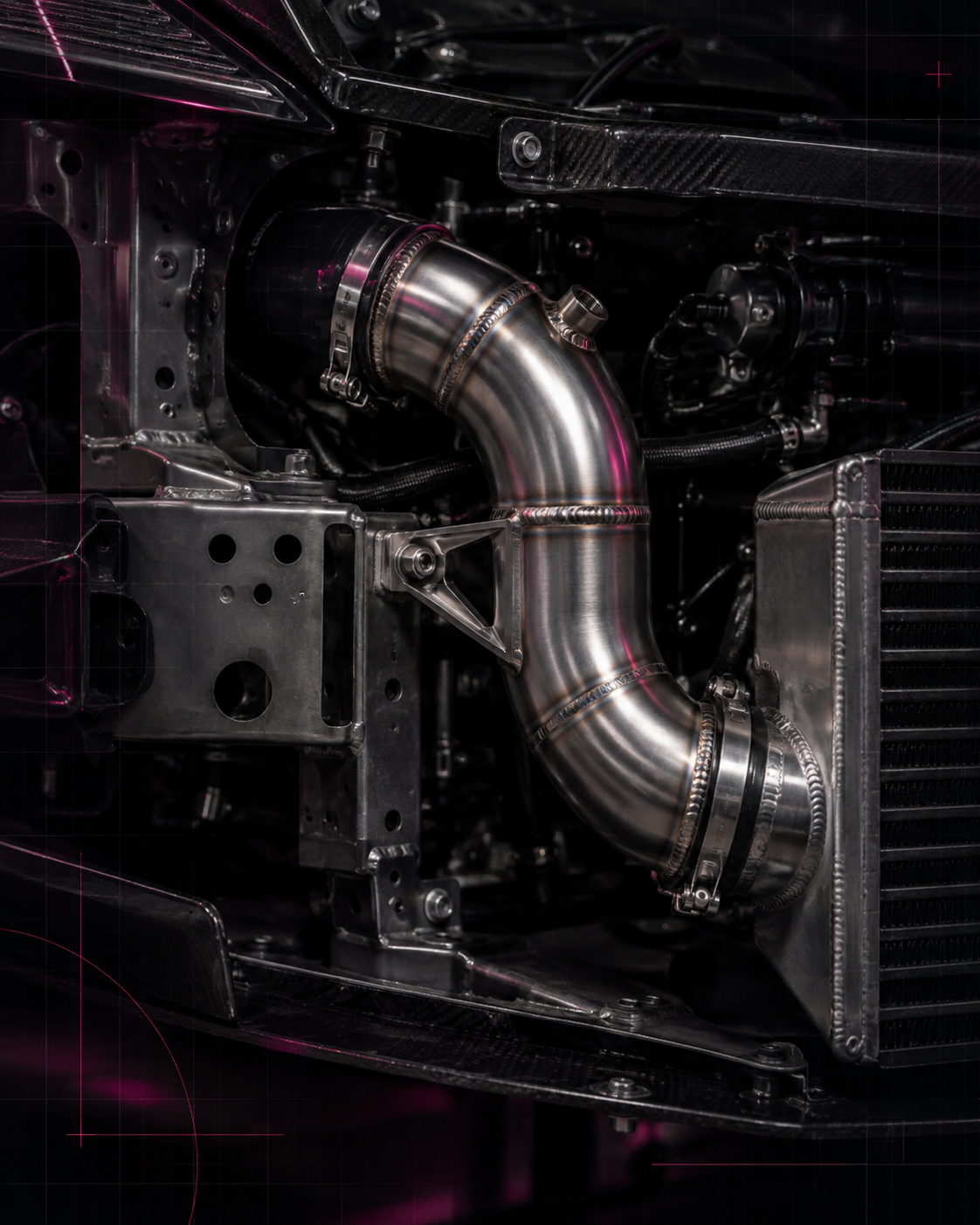 Welded metal pipework and a support bracket fitted around a performance car cooling system.