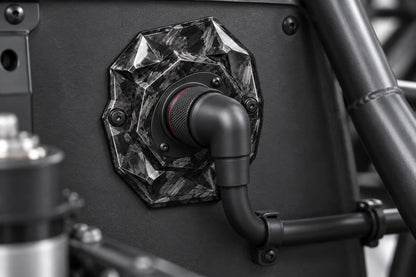 Large Dorifab single left forged carbon bulkhead plate installed on a motorsport firewall with a booted DR25 loom.