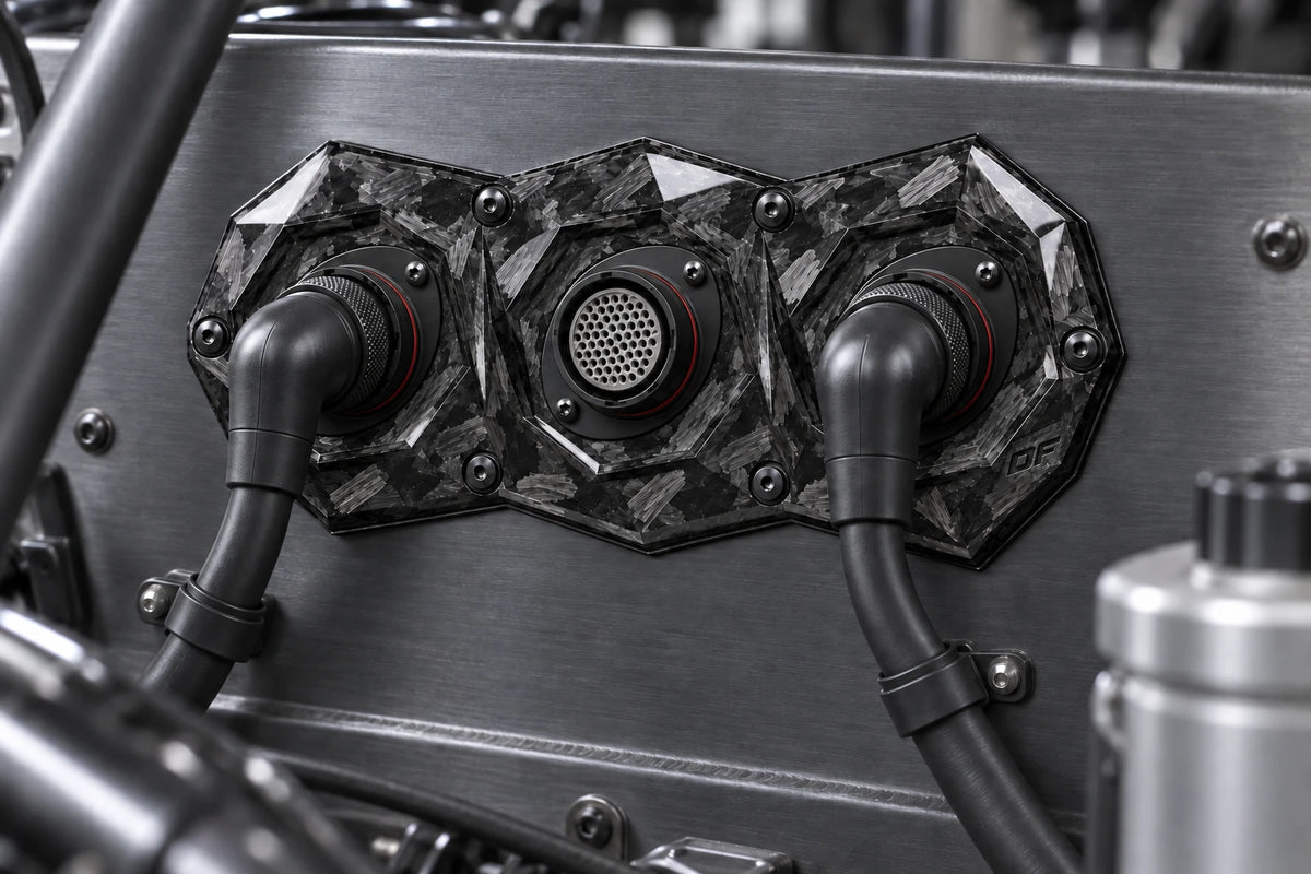 Large Dorifab triple forged carbon bulkhead plate installed on a motorsport firewall with a booted DR25 loom.